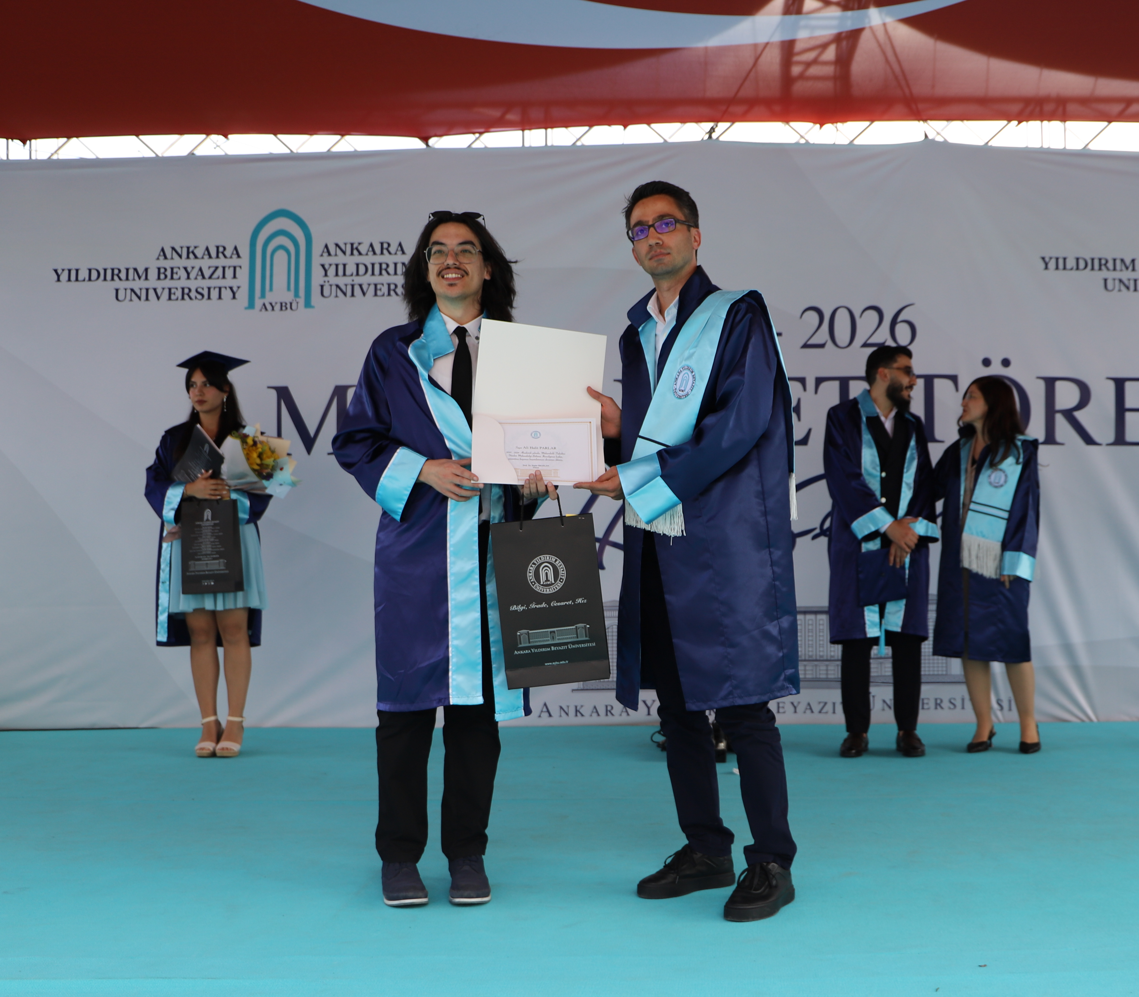 Our Vice Chair, Asst. Prof. Dr. Ömer Mintemur, presents the diploma and commemorative gift to our department's second-ranked graduate, Ali Halit Parlar.