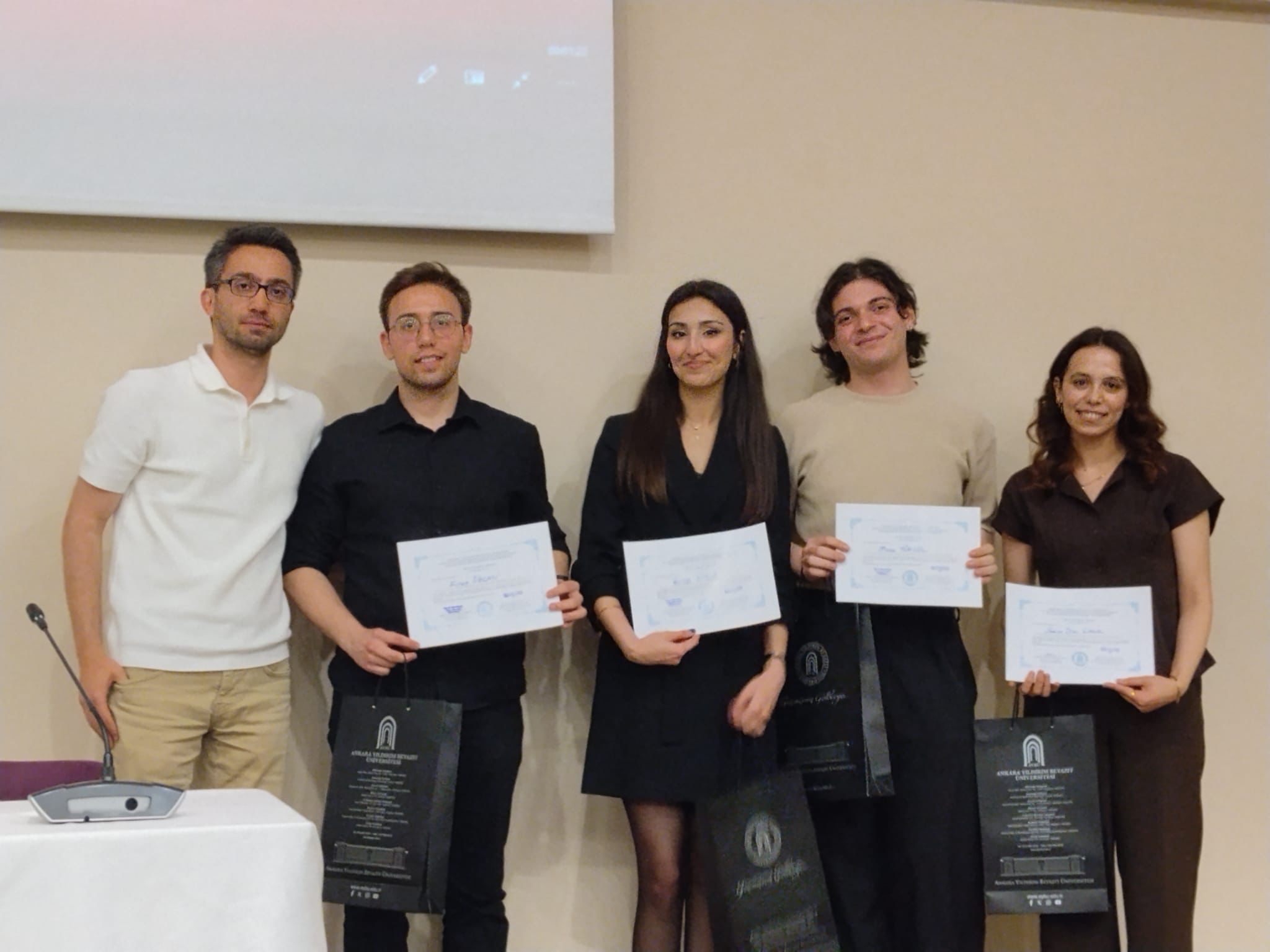 Fırat ÖZCAN, Rojda SÜSLÜ, Musa YÜKSEL, and Sena Dilan ÇAKIR, winners of the Best Poster Award, received their certificates together with their advisor, Assist. Prof. Dr. Ömer MİNTEMUR.