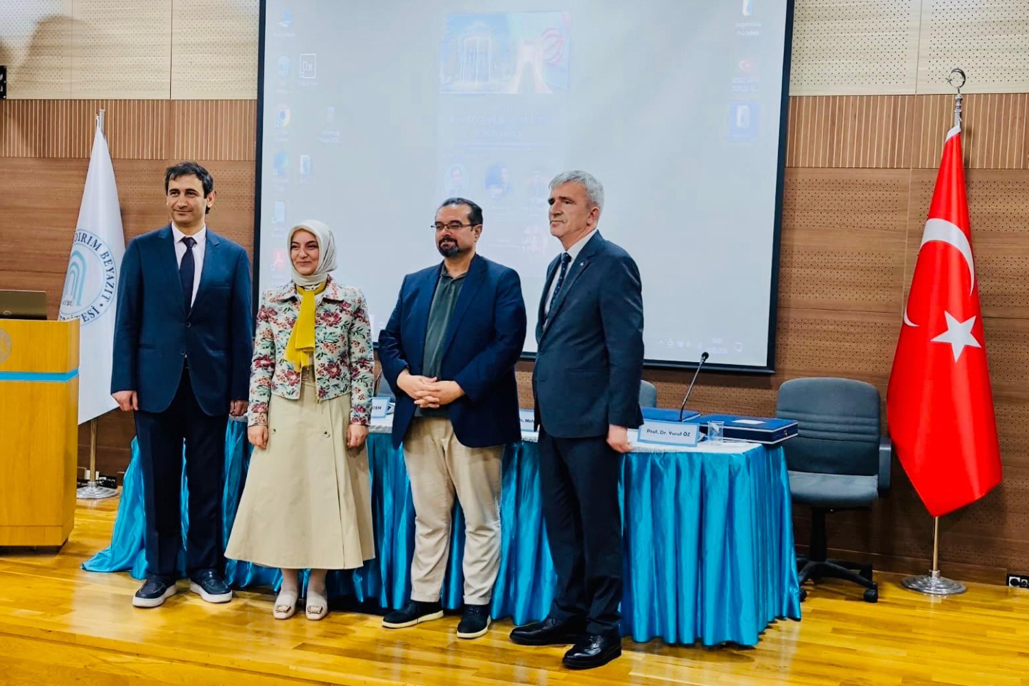 Photos of our professors participating in the panel, taken at the podium.