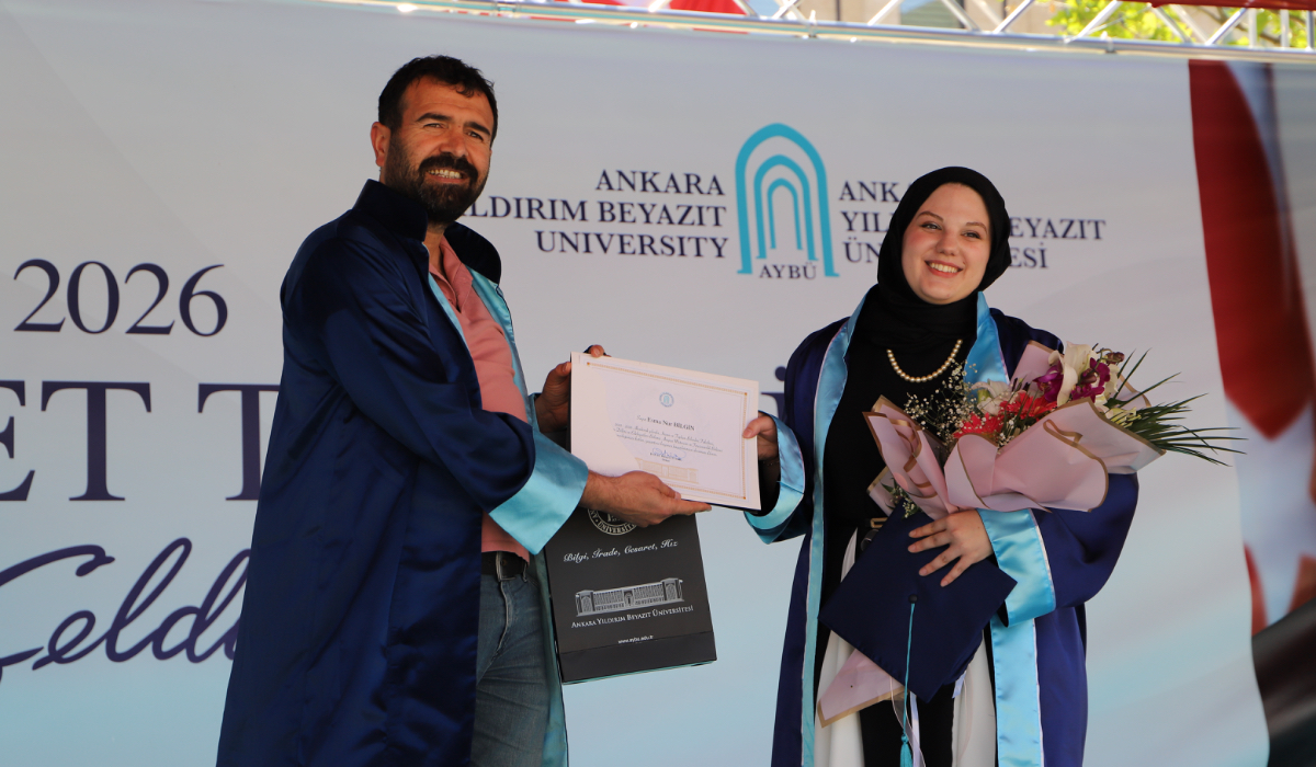 The third-ranking graduate of our department receives their diploma.